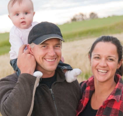 family with baby on farm
